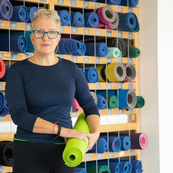 Woman smiling peacefully after a gentle exercise session.